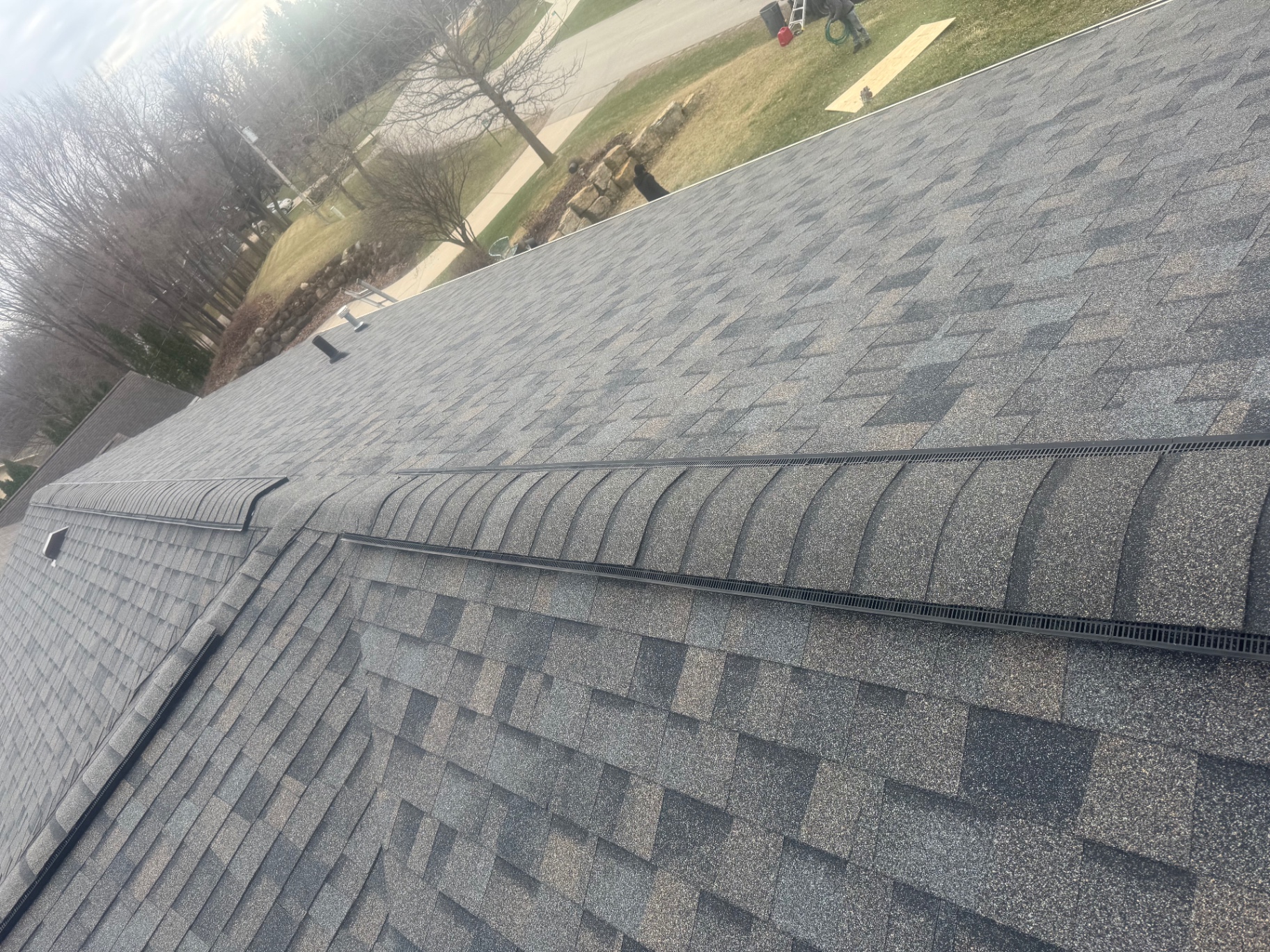 Close-up craftsmanship of ridge cap and shingle work